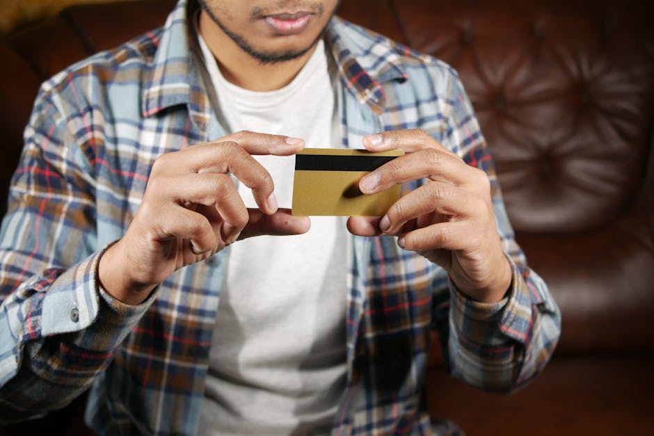 Person holding a credit card, focusing on hands and card for financial themes.